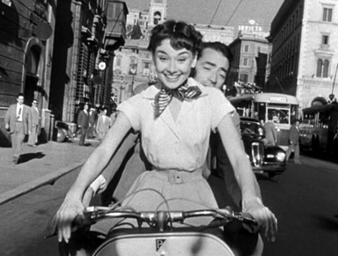 Audrey_Hepburn_and_Gregory_Peck_on_Vespa_in_Roman_Holiday_trailer_R.jpg